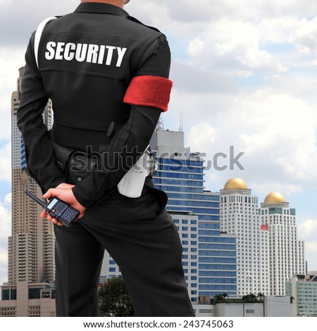 Close of of policeman\'s hand on his transmitter. Security agent surveillance guard.