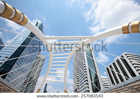 Bangkok city sathorn square terminal skywalk and sky train under blue sky