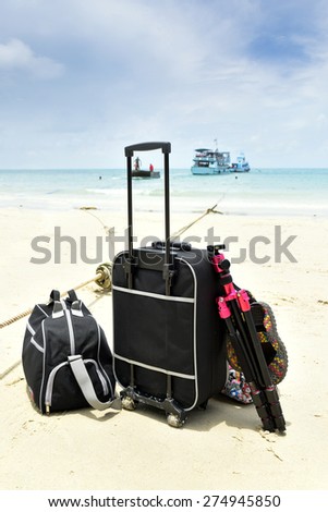 Luggage handling and tripods luxury vacation for travel luggage with the luggage on a background of blue sea. And vessels
