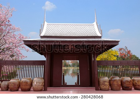 Wooden House high pitched roof elevated central Thailand Landscaped gardens, a large family residence.