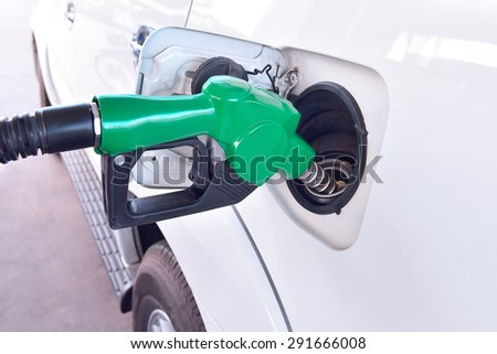 Fuel nozzle Car Gas Tank - Fueling Theme. Closeup. Transportation Photo Collection.