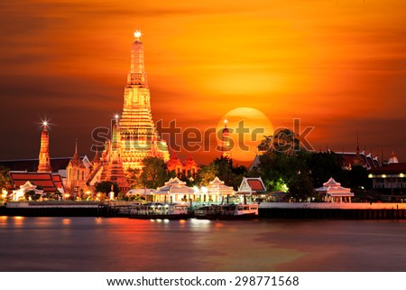 Wat Arun the Temple of Dawn during sun set on Chaophraya River Bangkok Thailand.