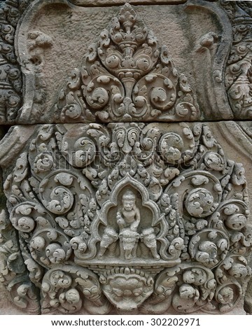 Art sandstone carvings in the ancient ornamental pediment above the entrance to the castle. Prasat Hin Muang Tum Historical Park, sand stone castle in Buriram, Thailand.