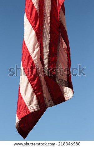 close detail of sewn stripes on United States states flag hanging down, no breeze