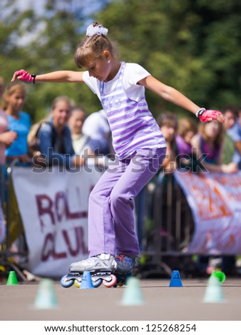 MOSCOW - JULY 21: Gorky Park, Anastasia Zenkova performs a style-slalom element - Russian Rollerskating Federation Championship on July 21, 2012 in Moscow
