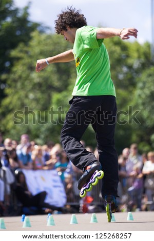 MOSCOW - JULY 21: Gorky Park, Viktor Meleshkevich performs a onewheel spin slalom element - Russian Rollerskating Federation Championship on July 21, 2012 in Moscow