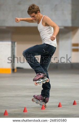 MOSCOW - JULY 26: Rollerskater Maxim Igaev (Russia) performs one-wheel spin element - Style-slalom Competition, World Cup 2008 Final held in Moscow, Russia on July 26, 2008.