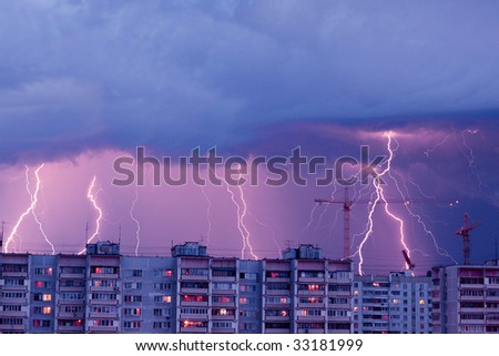 Lightnings in the sky - evening rainy city landscape