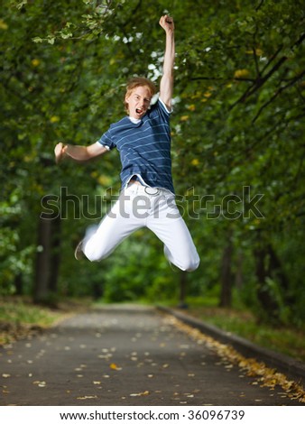 Jumping man in a park alley - shallow DOF and little motion blur