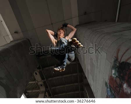 Wide angle shot of a jumping rollerskater on a dark urban background - with just a little motion blur