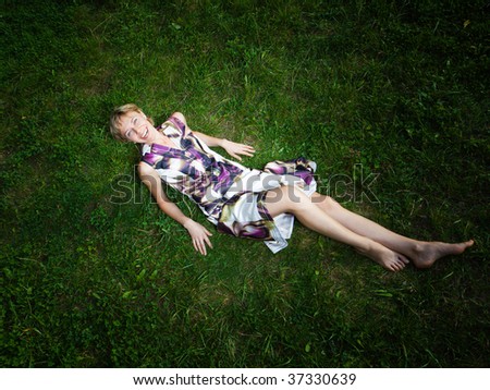 Wide angle shot of happy woman on the grass