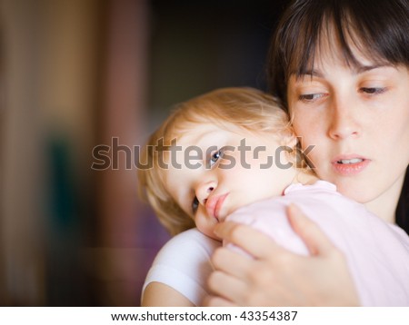 Sleepy little child with mom - shallow DOF, focus on little girl\'s eyes