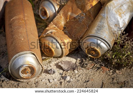 Rusty Spray Cans. It is a detail of a street art and graffiti. Some of used and empty aerosol cans.
