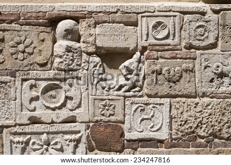 Wall with antique stones from the classical greek architecture, with historical inscriptions some hundred years before Christ. (Was seen in Italy.)