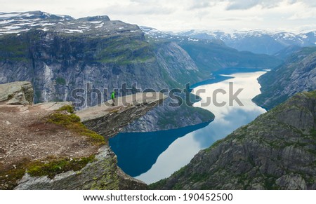 Beautiful summer vibrant view on Norwegian fjord with a house, forest, rocks, blue sky and reflection. Norway Mountain Vibrant Landscape Trolltunga Odda Fjord Norge Hiking Trail