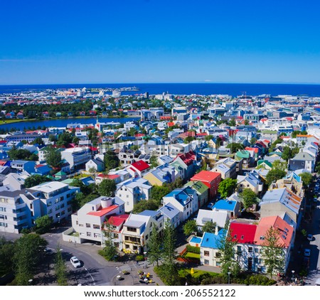 Beautiful super wide-angle aerial view of Reykjavik, Iceland with harbor and skyline mountains and scenery beyond the city, seen from the observation tower of Hallgrimskirkja Cathedral,