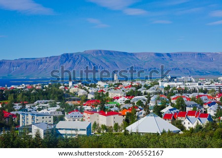 Beautiful super wide-angle aerial view of Reykjavik, Iceland with harbor and skyline mountains and scenery beyond the city, seen from the observation tower of Hallgrimskirkja Cathedral,
