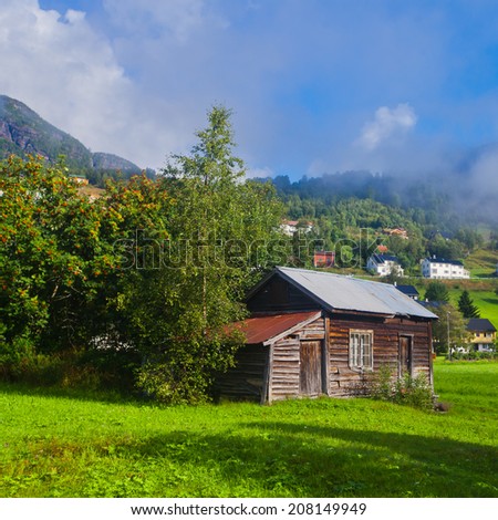 Beautiful norwegian village Roldal with scandinavian cottages, mountains and lake, summer in Norway