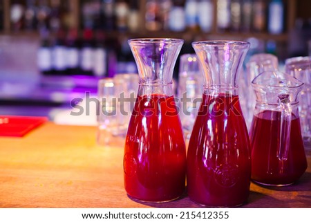 Beautiful line of different coloured cocktails on a open air party, tequila, martini, vodka, and others on decorated catering table on open air party