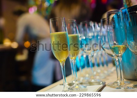 Beautiful line of different coloured cocktails with smoke on a open air party, tequila, martini, vodka, and others on decorated catering bouquet table on open air party