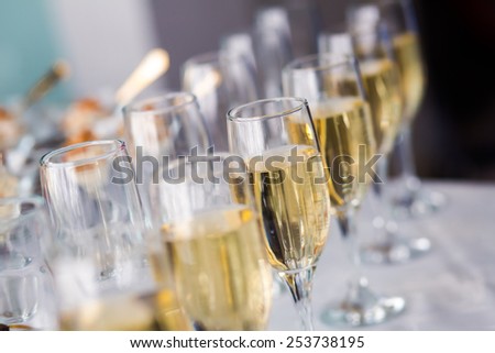 Beautiful line of different colored cocktails with smoke on a open air party, tequila, martini, vodka, and others on decorated catering bouquet table on open air party