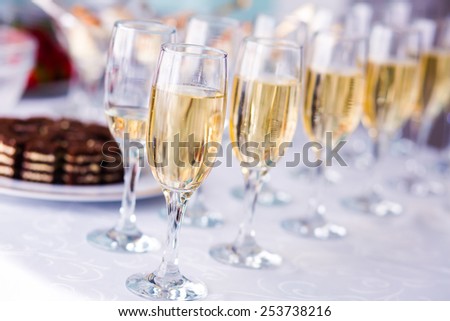 Beautiful line of different colored cocktails with smoke on a open air party, tequila, martini, vodka, and others on decorated catering bouquet table on open air party