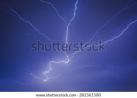 Very big lightning on the city, night cityscape with strong lightning, majestic view on night town in dark stormy night