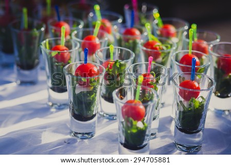 Beautifully decorated catering banquet table with different food snacks and appetizers with sandwich, caviar, fresh fruits on corporate party event or wedding celebration