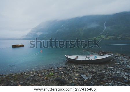 Beautiful norwegian summer landscape with mountains, boat, lake and fjord, Norway