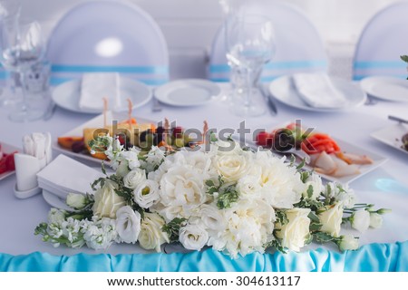 Beautiful wedding table and interior decoration with flowers in blue colors