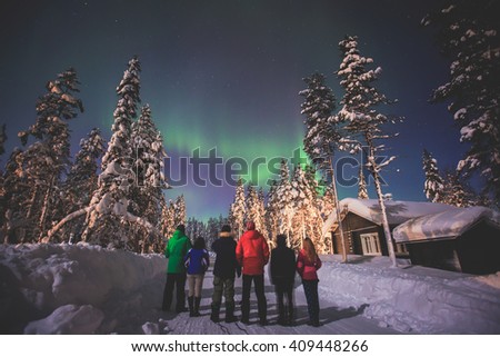 Beautiful picture of massive multicoloured green vibrant Aurora Borealis, Aurora Polaris, also know as Northern Lights in the night sky over winter Lapland landscape, Norway, Scandinavia