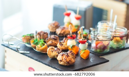 Beautifully decorated catering banquet table with different food snacks and appetizers on corporate christmas birthday party event or wedding celebration