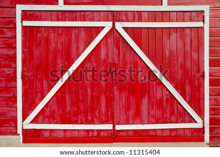 Red barn doors with the supports on the outside.