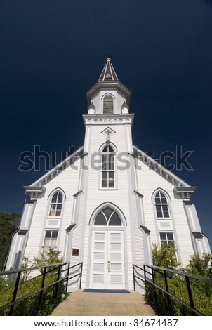 Front architectural view of a classical white wooden church.