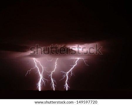 An amazing triple strike on lightning in the desert sky.