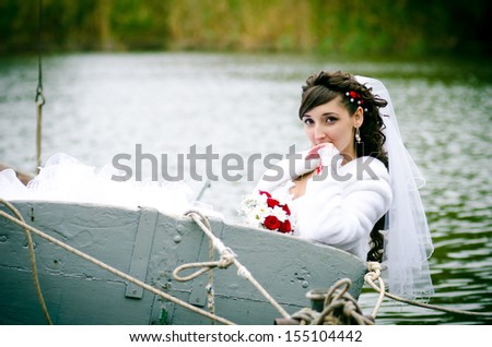 Bride on a yacht with white sails. Wedding at the sea on a yacht.