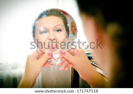 bride looks in the mirror and smiling, morning routine