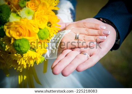 hand in hand. Bouquet of yellow flowers