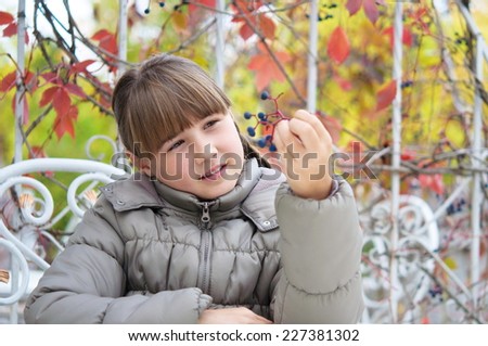 girl with wild grapes in the autumn in the cafe