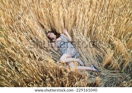 girl in rye field. girl lies on an ear of wheat. Wheat field. spikelet