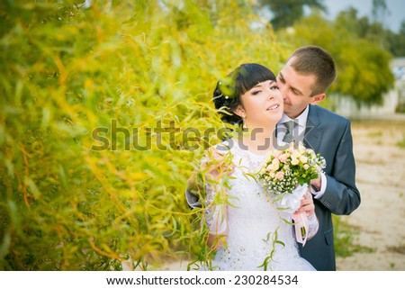wedding in the fall. bride and groom among yellow leaves