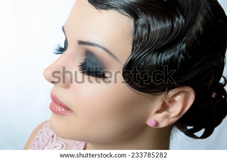 Beauty Portrait. portrait of a girl with false eyelashes on a white background. Beauty salon. hair style. face on a white background.