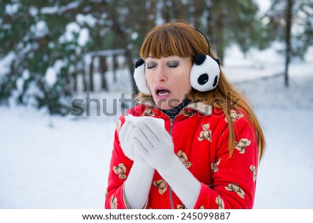 girl in winter forest coughs. Young woman woman coughs winter park