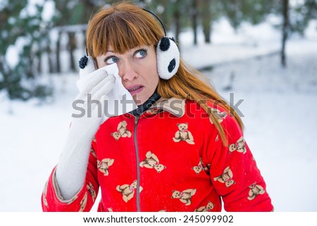 girl in winter forest coughs. Young woman woman coughs winter park