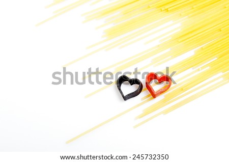 Italian pasta hearts shaped. spaghetti on a white background. two colored hearts. man and woman. love