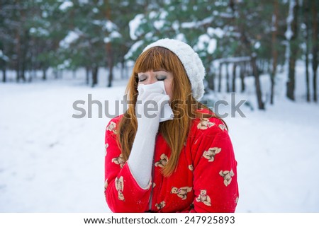 angina winter, runny nose in the winter season allergy to the cold, the flu virus in adults. girl in winter forest coughs