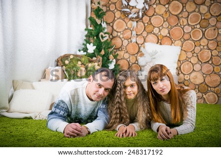 Smiling family home evening.  winter evening together at home. promote family values. family home evening, mom, dad and daughter