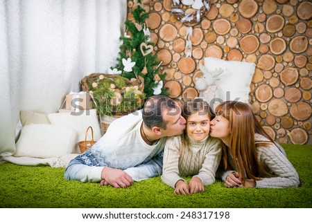 Smiling family home evening.  winter evening together at home. promote family values. family home evening, mom, dad and daughter
