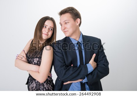girl and guy together on a white background. Teens do not understand each other. couple in quarrel