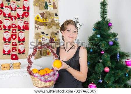 Portrait of woman decorating christmas tree. hostess decorates a Christmas tree before the holiday